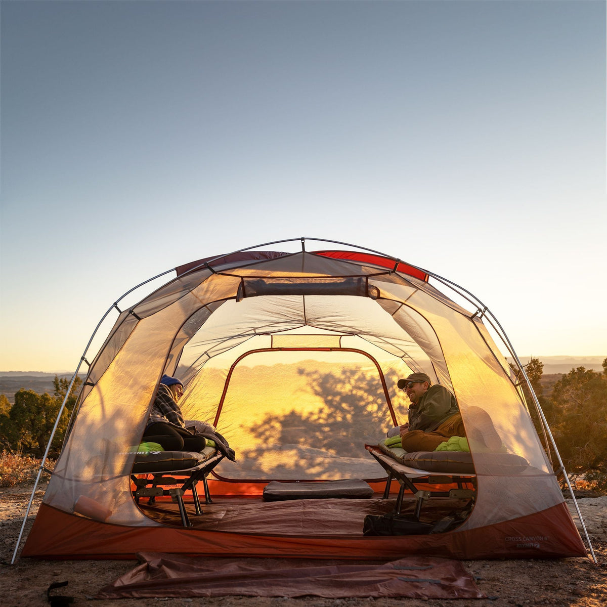 Inside the Klymit Cross Canyon 6 Tent at sunset with two camp stretchers