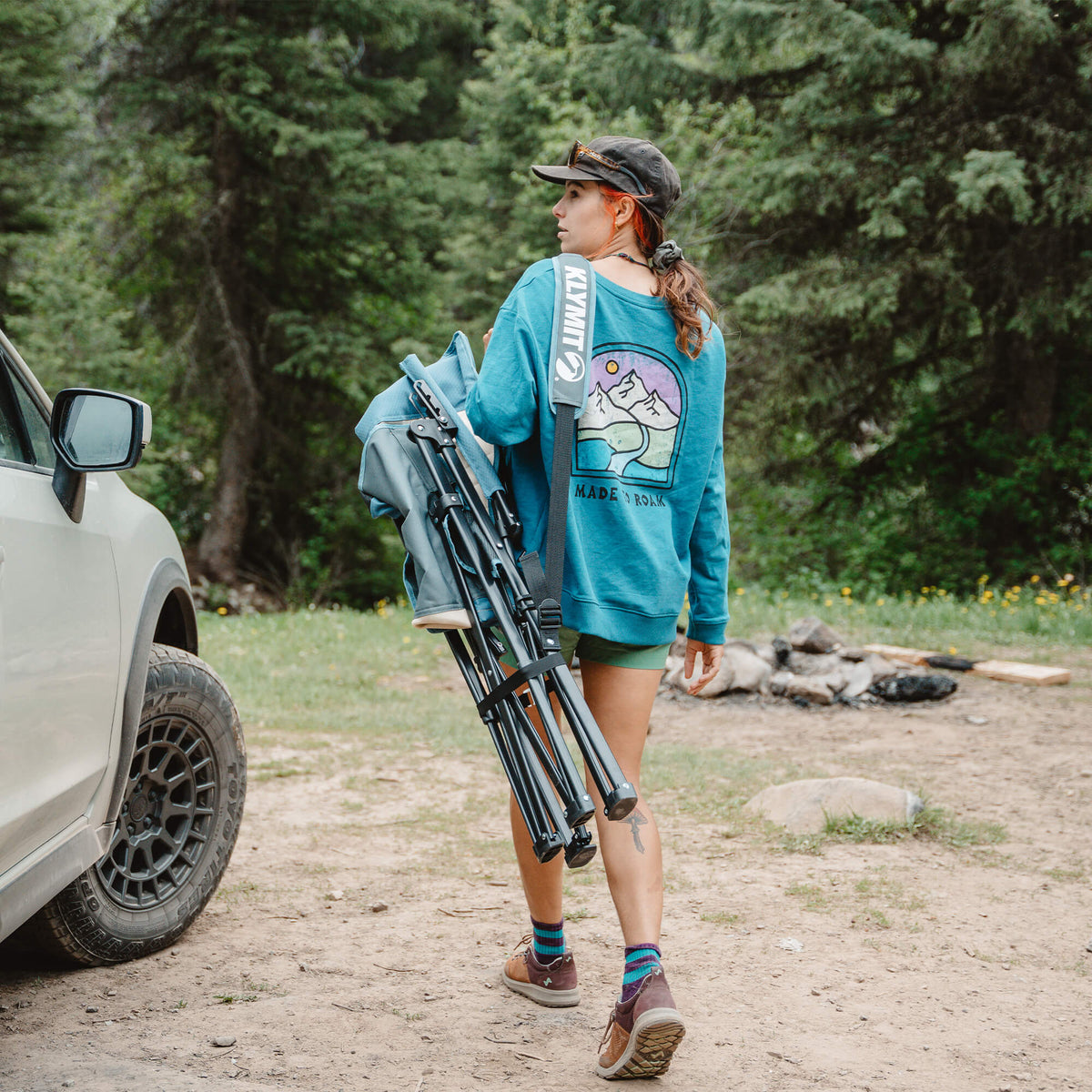 Carrying the folded Klymit Switchback Camp Chair by its strap