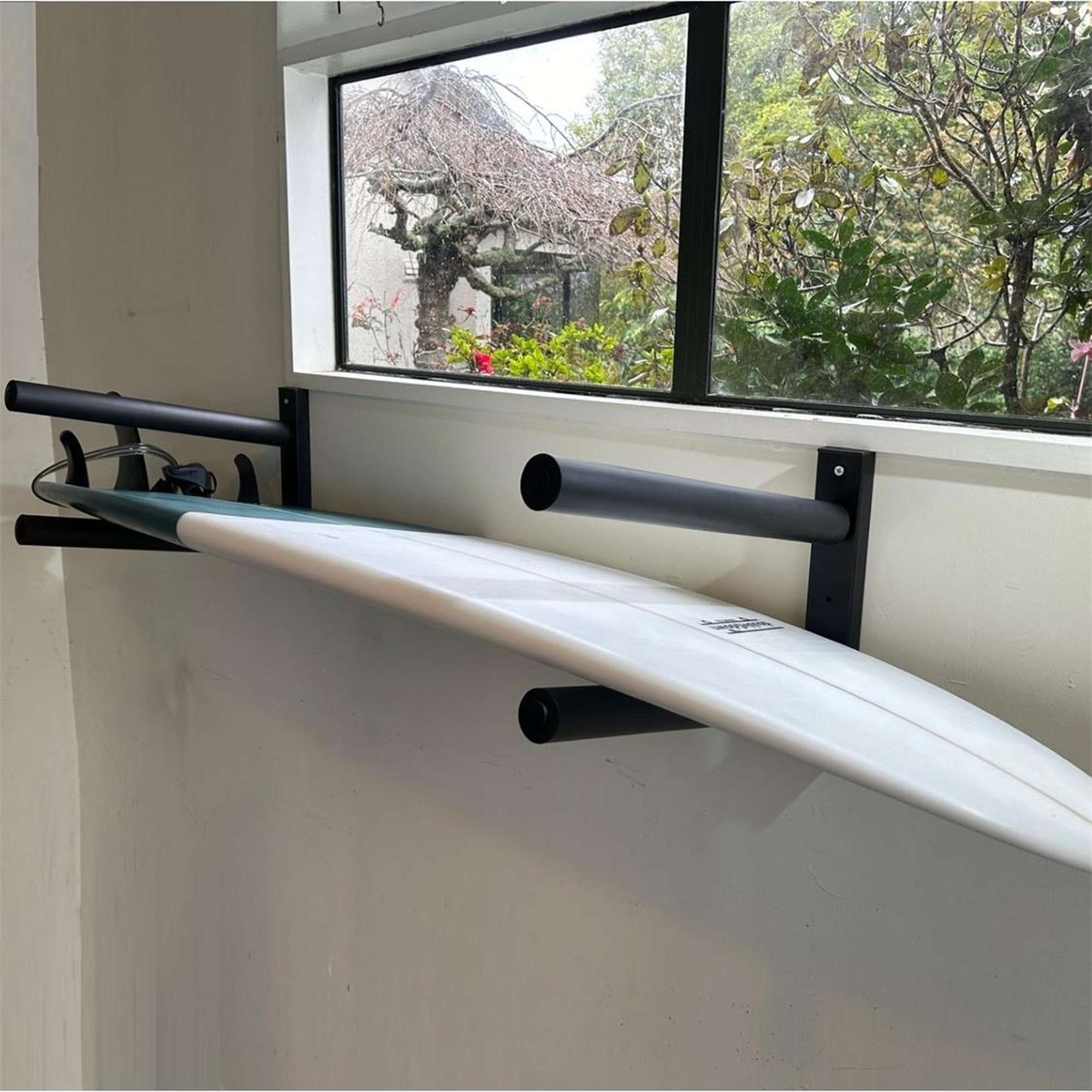 Double$down 2 board wall rack - pair, holding a surfboard