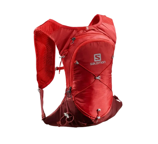 A red Salomon running backpack shown on a plain white background. The backpack features a breathable mesh back panel, multiple zippered compartments, and the Salomon logo on the front.